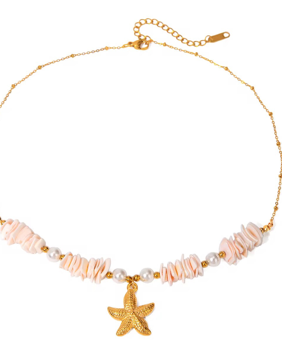 A gold-colored necklace with a starfish pendant and small ivory stones.