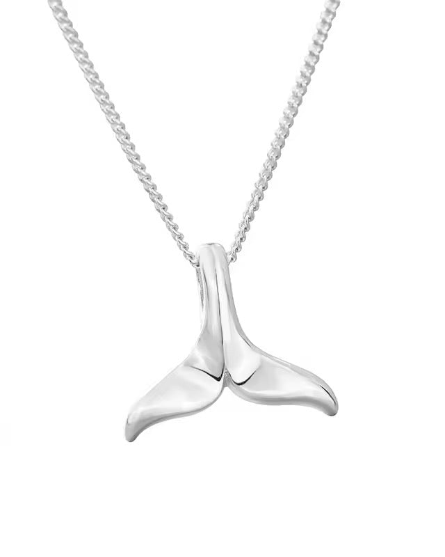 A silver necklace with a whale tail pendant, on a chain against a white background.