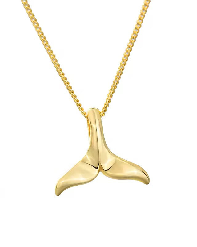 An 18K gold-plated necklace with a whale tail pendant, on a gold chain.