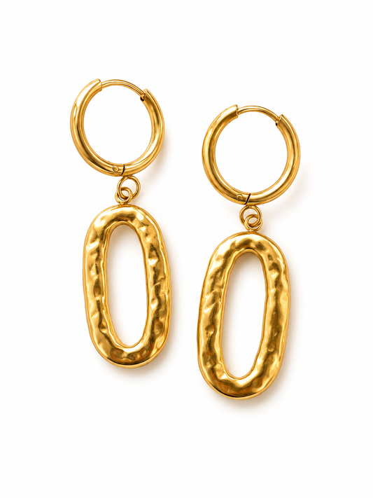A pair of gold hoop earrings with textured, elongated oval dangles, displayed on a clean white background.