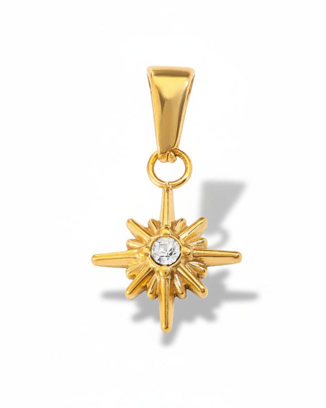 Gold star-shaped pendant with a central gemstone on a white background