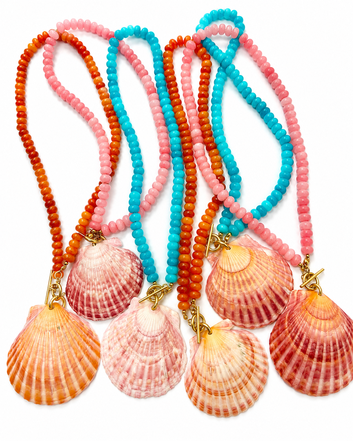 Four beaded necklaces with scallop shell pendants, featuring orange, turquoise, and pink beads with gold-tone clasps, displayed on a white background.