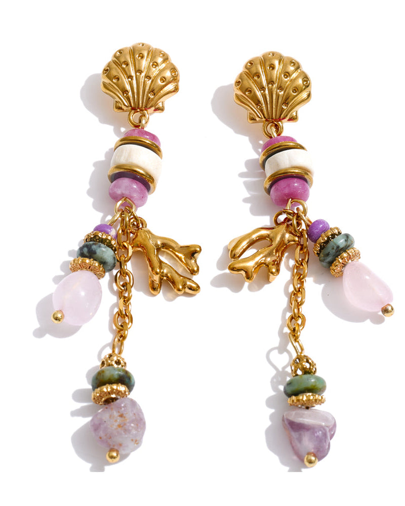Pair of gold earrings with shell and bead designs on a white background