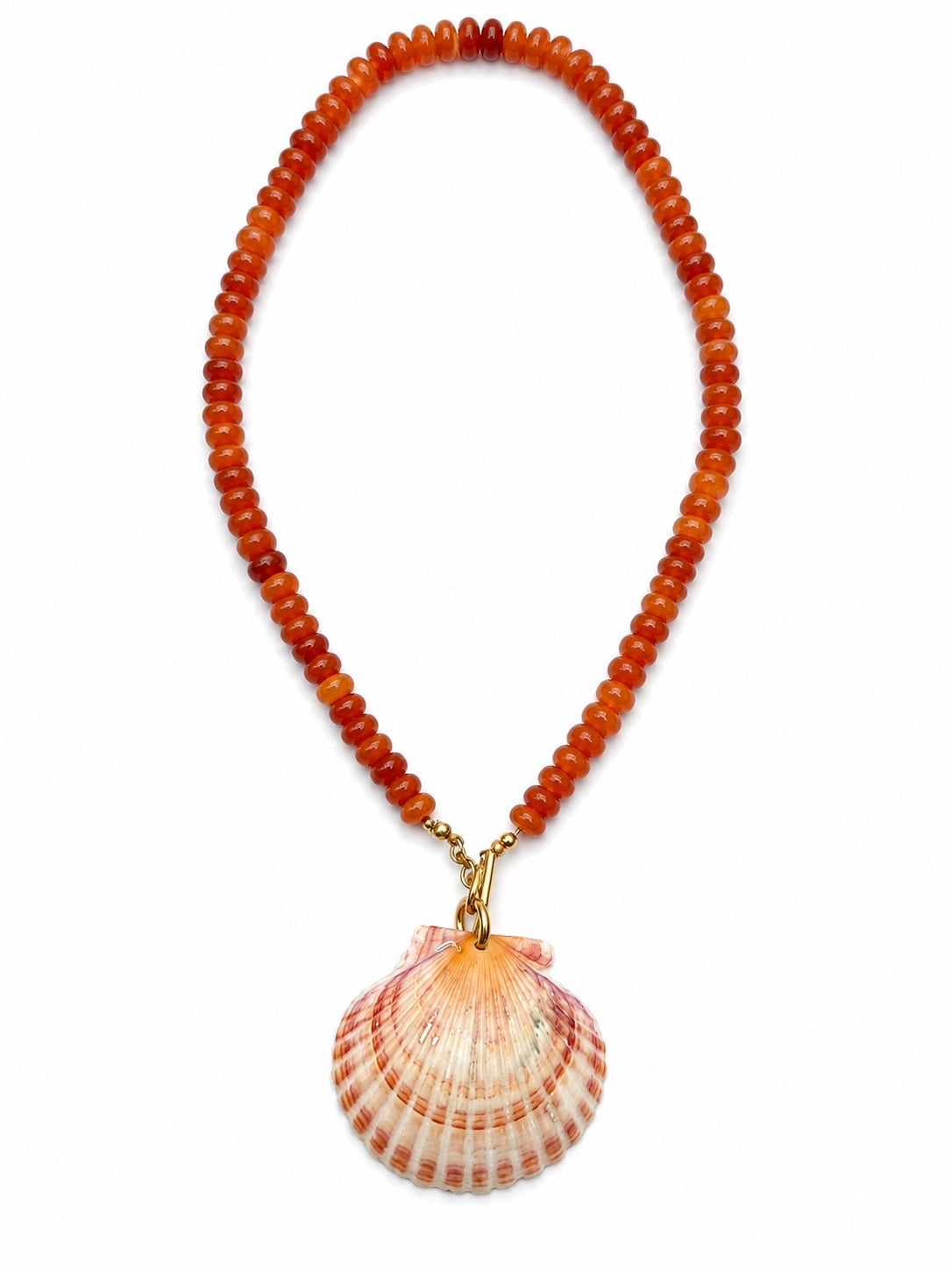 A beaded necklace made of round orange-brown beads with a large scallop shell pendant hanging from gold-tone hardware, shown on a plain white background.
