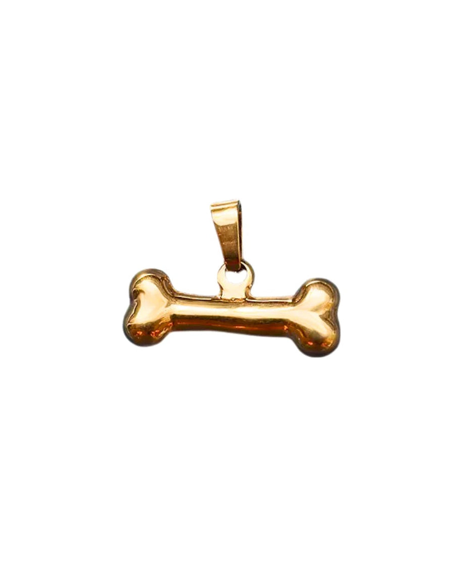 Gold bone-shaped pendant on a white background